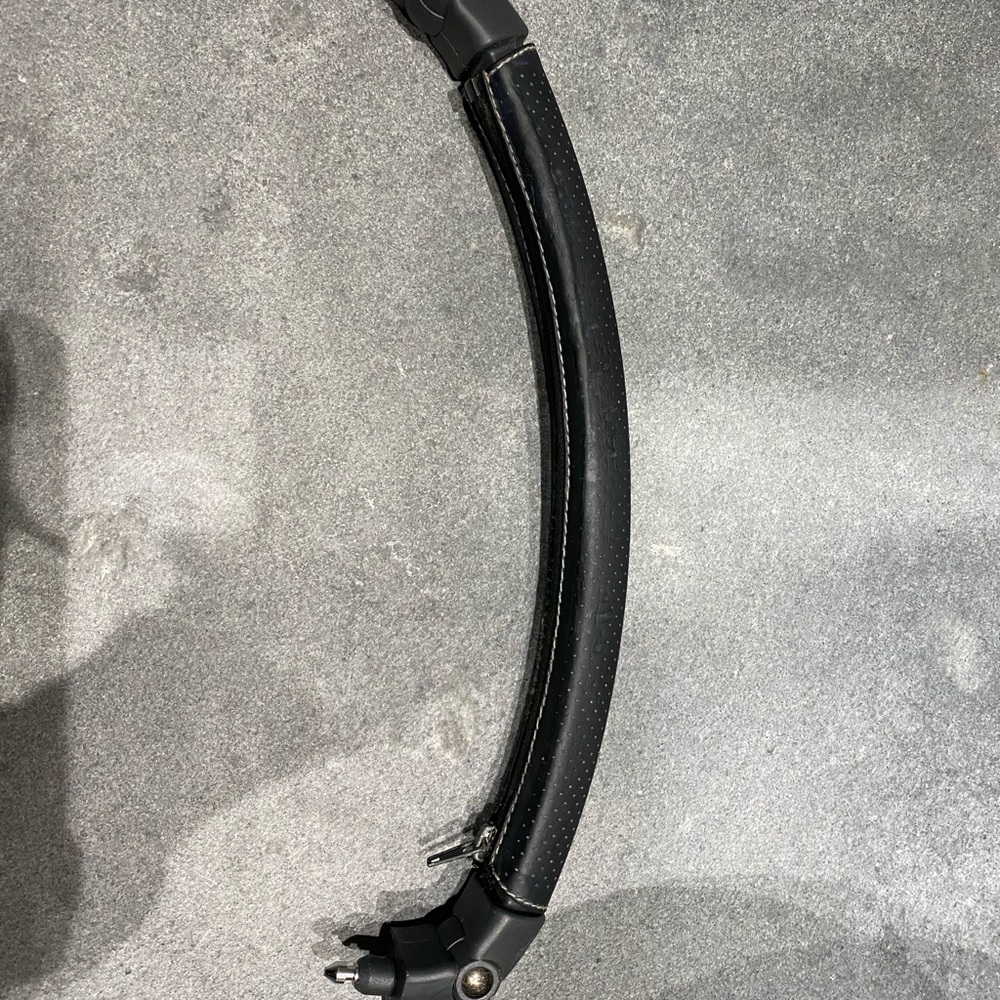 Uppababy bumper bar with black leather covering.